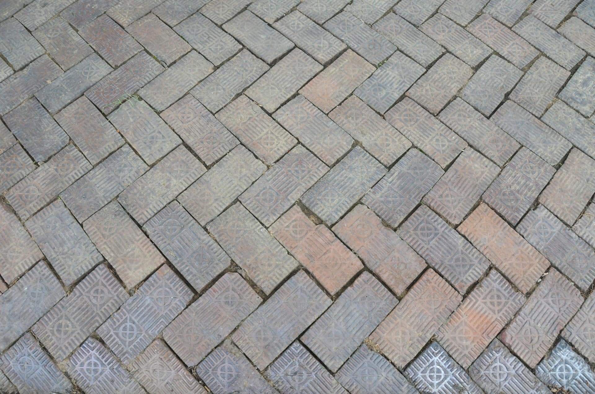 Herringbone block paving pattern in weathered brick